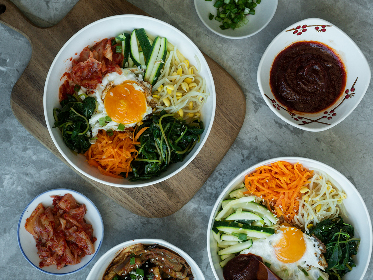 Korean banchan side dishes including kimchi, bibimbap, and gochujang
